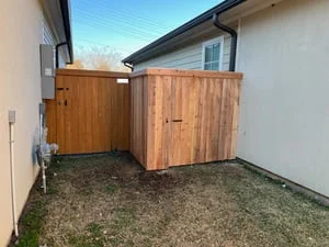 Two cedar wood gates installed in residential side yard with natural finish